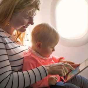 On A Flight A Passenger Playing With Her Baby