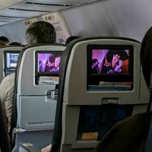 Passengers On A Flight Enjoying Movie